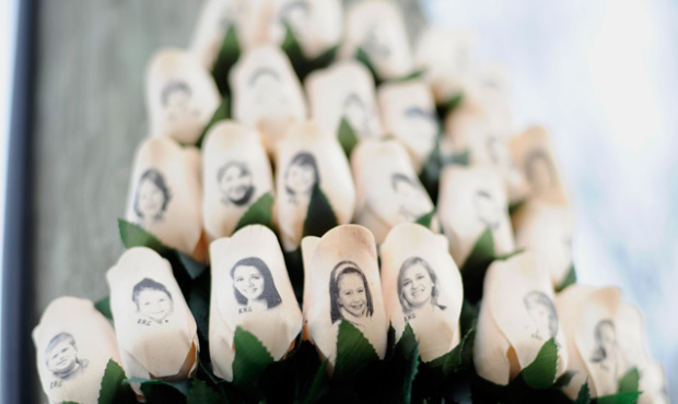 White roses bearing the faces of victims of the Sandy Hook Elementary School shooting are displayed...