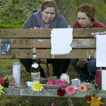Kurt Cobain fans Kristin Nelson,18, left, and Amberae Poorman, 18, both from Auburn, read the messages Monday April 5, 2004, left on the park bench next to the home where Kurt Cobain died 10 years ago in Seattle. Cobain fans gathered on the 10th anniversary of the Seattle singer/songwriters suicide. 