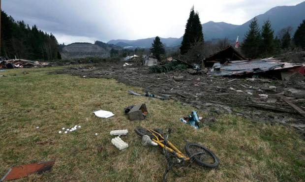 A child’s bicycle is with other remains at the edge of the scene of a deadly mudslide from th...