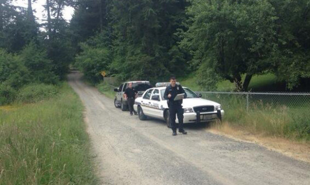 Police search the area Tuesday where a Tacoma teen reported killing and burying his father. (Photo ...