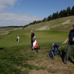  In this April 1, 2013 photo, golfers walk away from the eighth hole at Chambers Bay in University Place, Wash. In 2015, the course will become the first Pacific Northwest golf course to host the U.S. Open, but all the physical changes required by the tournament are essentially complete. (AP Photo/Ted S. Warren)