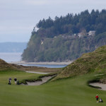  In this April 1, 2013 photo, golfers play the tenth hole at Chambers Bay in University Place, Wash. In 2015, the course will become the first Pacific Northwest golf course to host the U.S. Open, but all the physical changes required by the tournament are essentially complete. (AP Photo/Ted S. Warren)
