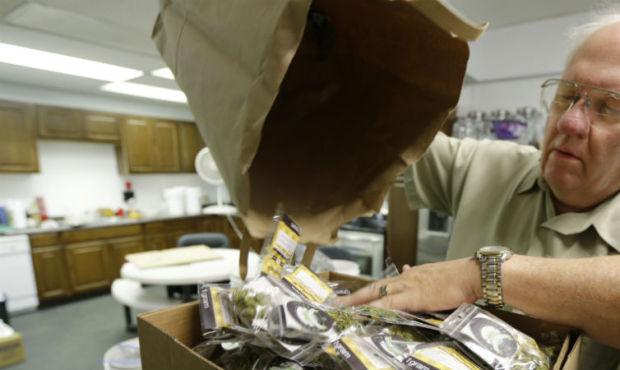Bob Leeds, owner of Sea of Green Farms, pours packets of recreational marijuana into boxes at his b...
