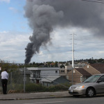 Large plumes of smoke coming from a fire in Fremont are seen from Seattle's Eastlake neighborhood. The fire at a metal processing plan broke out shortly before 1 p.m., Tuesday, Sept. 30, 2014.
