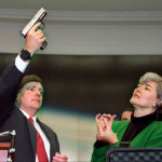 In this file from 1996, Rep. Pat Schroeder, D-Colo. reacts as Colt Manufacturing Vice President Doug Overbury shows his company's Smart Gun during a Capitol Hill news conference Wednesday Sept. 18, 1996. The gun, a standard-looking .40-caliber, semi-automatic pistol can only be activated from a pea-size radio transmitter worn on the wrist of an authorized shooter. (AP Photo/Mark Wilson)
