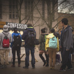 Students line up to check out the Confession Board at the UW. 