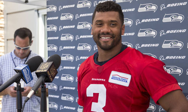 Russell Wilson got out his green thumb at Seattle’s Dunlap Elementary, planting native plants...