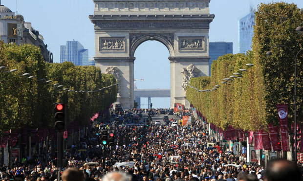 People walk on the Champs Elysees during the “day without cars”, in Paris, France on Se...