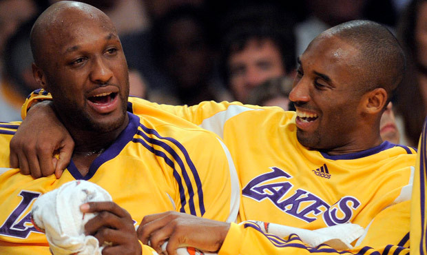Los Angeles Lakers guard Kobe Bryant, right, talks with forward Lamar Odom. Odom, who was embraced ...