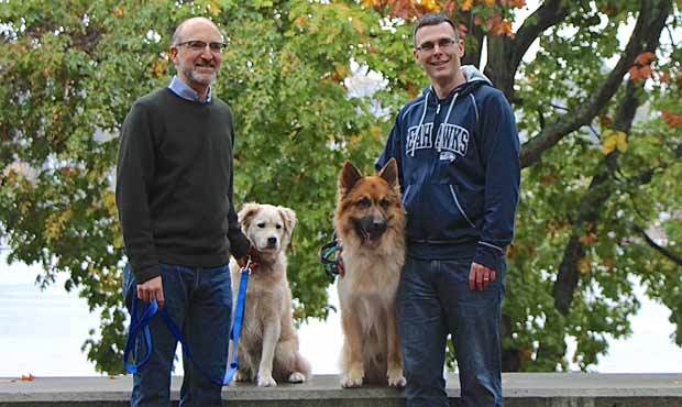 Professor Daniel Promislow, left, and Professor Matt Kaeberlein pose with their pups. (Courtesy of ...