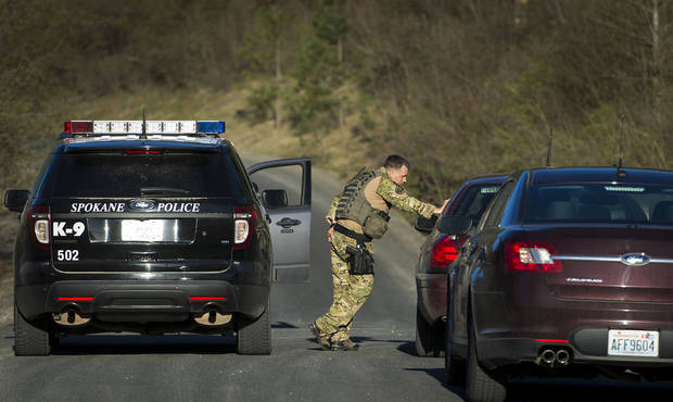 Officials stop vehicles as they search in Spokane Valley on April 7 for escaped mental patient Anth...