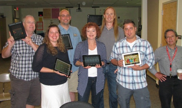 Teachers at 10th Street Middle School in Marysville show off their Ipads as they prepare for an all...