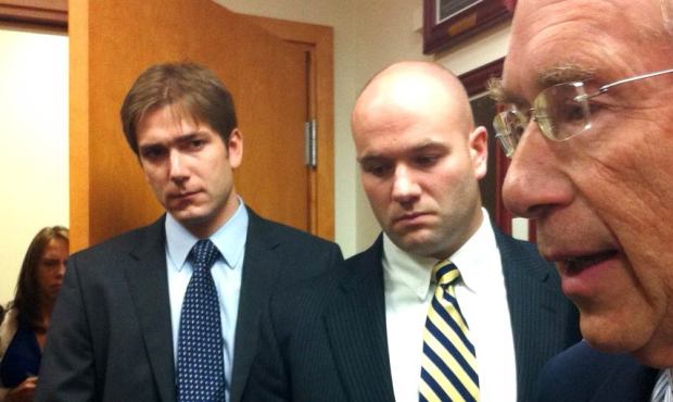Officer Derek Carlile (center), leaves a courtroom in Everett Tuesday as his defense attorney, Davi...