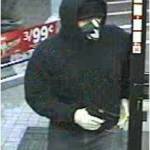 The robber wears a hood and bandanna.