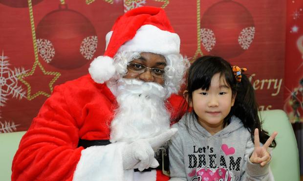 A little girl at Bikou-En Orphanage visits with Santa this past Christmas. (Misawa Naval Air Facili...
