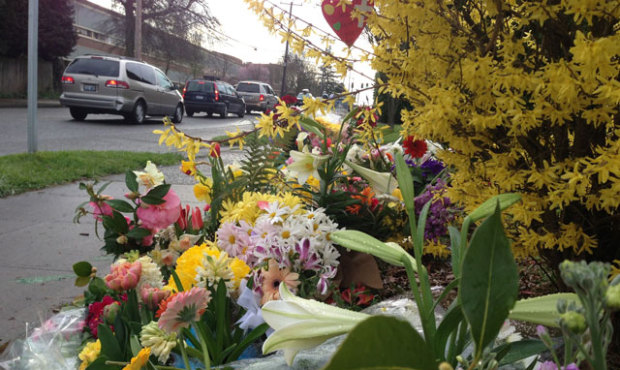 Flowers are placed at the intersection of NE 75th Street and 33rd Ave NE in Seattle, near the accid...