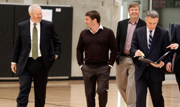 Seattle Mayor Mike McGinn, left, walks with investor Chris Hansen, second from left, along with Sea...