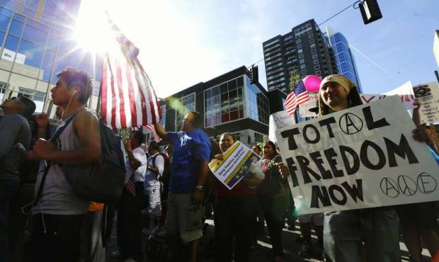 Protesters march in a May Day rally for immigration rights, Wednesday, May 1, 2013 in downtown Seat...