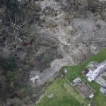 In this aerial photo, a house sits near the bottom edge of a landslide near Coupeville, Wash. on Whidbey Island, Wednesday, March 27, 2013. (AP Photo/Ted S. Warren)