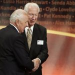 Inductee Richie Guerin, left, clasps hands with Hall of Famer John Havlicek, right, after addressing the audience during the enshrinement ceremony for this year's class of the Basketball Hall of Fame, at Symphony Hall in Springfield, Mass., Sunday, Sept. 8, 2013. (AP Photo/Steven Senne)