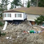 This March 27, 2013 photo provided by the Washington Dept. of Natural Resources, shows a home that was damaged by the massive landslide that also isolated or threatened more than 30 others near Coupeville, Wash. (AP Photo/Washington Dept. of Natural Resources, Stephen Slaughter)