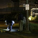 Police officers place evidence markers at the scene of an overnight shooting that left five people dead, Monday, April 22, 2013, at the Pinewood Village apartment complex in Federal Way, Wash. (AP Photo/Ted S. Warren)