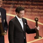 Inductees Oscar Schmidt, left, of Brazil, and Rick Pitino, right, hold their trophies during the enshrinement ceremony for the 2013 class of the Naismith Memorial Basketball Hall of Fame at Symphony Hall in Springfield, Mass., Sunday, Sept. 8, 2013. (AP Photo/Steven Senne)