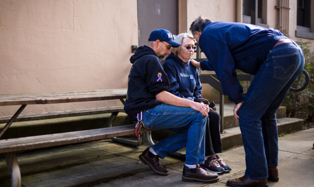 Barbara Welsh, center, a mudslide victim whose husband is still missing, is comforted by Washington...