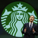 Howard Schultz, chairman and CEO of Starbucks Coffee Company, speaks Wednesday, March 19, 2014, at the company's annual shareholders meeting in Seattle. (AP Photo/Ted S. Warren)