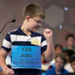 Fifth grade student Joel Miles, 11, of Eagle Glen Intermediate School, Raymore, Miss., pumps his fist after spelling correctly the word, "sporran", during the preliminaries, round three of the Scripps National Spelling Bee, Wednesday, May 28, 2014, at National Harbor in Oxon Hill, Md. (AP Photo/Manuel Balce Ceneta)