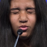 Alexandra Harper, of Guayama, Puerto Rico, concentrates before spelling the word "Bildungsroman" during the preliminary round of the National Spelling Bee, Wednesday, May 28, 2014, in Oxon Hill, Md. (AP Photo/Evan Vucci)
