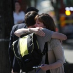 Onlookers embrace near the scene of a shooting at Seattle Pacific University on Thursday, June 5, 2014 in Seattle. About 4,270 students attend the private Christian university, located in a residential neighborhood about 10 minutes from downtown Seattle. (AP Photo/seattlepi.com, Joshua Trujillo)