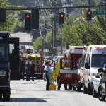 Medical workers stow an used backboard at the scene of a shooting Thursday, June 5, 2014 at Seattle Pacific University in Seattle. About 4,270 students attend the private Christian university, located in a residential neighborhood about 10 minutes from downtown Seattle. (AP Photo/Ted S. Warren)