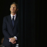 Howard Schultz, chairman and CEO of Starbucks Coffee Company, waits in the wings before the opening of the company's annual shareholders meeting Wednesday, March 19, 2014, in Seattle. (AP Photo/Ted S. Warren)