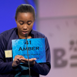 Eighth grader Amber Robinson, 14, of Herbert A. Ammons Middle School, Miami, Fla., uses her palm to write her word and spell, during the preliminaries, round two of the Scripps National Spelling Bee, Wednesday, May 28, 2014, at National Harbor in Oxon Hill, Md. Robinson spelled her word gourami, correct. (AP Photo/Manuel Balce Ceneta)