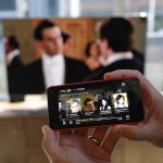 The feature that lets the new Amazon Fire Phone send a movie or TV show wirelessly to a compatible television while the the phone serves as a "second screen" to display information about actors, locations, and scenes is shown, Wednesday, June 18, 2014, in Seattle. (AP Photo/Ted S. Warren)
