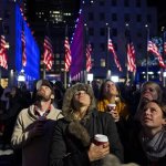 People watch election results displayed on a utility lift suspended from the front of the GE Building at Rockefeller Center, in New York, Tuesday, Nov. 6, 2012. From center left are Bryan Fletcher of Park City, Utah; Jen Hudak, Salt Lake City; Lindsay Arnold, Park City; K.C. Oakley, Park City, and Emily Cook, Park City. After a year of campaigning, polls have begun to close after Americans across the United States headed to the polls to decide the winner of the tight presidential race between President Barack Obama and Republican presidential candidate, former Massachusetts Gov. Mitt Romney. (AP Photo/Craig Ruttle)