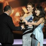 Zooey Deschanel, right, and Emily Deschanel present the award for outstanding supporting actor in a comedy series to Tony Hale, left, on stage at the 65th Primetime Emmy Awards at Nokia Theatre on Sunday Sept. 22, 2013, in Los Angeles. (Photo by Chris Pizzello/Invision/AP)