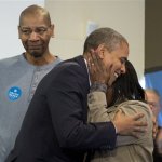 President Barack Obama is embraced by a volunteer as he visits a campaign office the morning of the 2012 election, Tuesday, Nov. 6, 2012, in Chicago. (AP Photo/Carolyn Kaster)