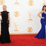 Amy Poehler, wearing Brian Rennie for Basler, left, and Tina Fey, wearing Narciso Rodriguez, arrive at the 65th Primetime Emmy Awards at Nokia Theatre on Sunday Sept. 22, 2013, in Los Angeles. (Photo by Jordan Strauss/Invision/AP)
