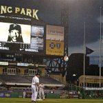 Rain falls over PNC Park during the second inning of a baseball game between the Pittsburgh Pirates and St. Louis Cardinals in Pittsburgh, Tuesday, April 16, 2013. The flags few at half staff in memory of the victims of the Boston Marathon explosions. Play was suspended in the bottom of the second inning due to weather. (AP Photo/Gene J. Puskar)