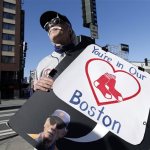 Detroit Tigers' fan Tab Waterman, of Portland, Ore., holds a sign in honor of the victims of the Monday bombings at the Boston Marathon as he stands outside the Seattle Mariners' ballpark before a baseball game against the Tigers Tuesday, April 16, 2013, in Seattle. Waterman is dressed as Tigers manager Jim Leyland. (AP Photo/Elaine Thompson)