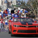 The 2014 Super Bowl MVP Malcolm Smith, a Seattle Seahawks linebacker, tosses a football as he rides in a parade at Walt Disney World with Mickey Mouse, Monday, Feb. 3, 2014, in Lake Buena Vista, Fla. The Seahawks defeated the Denver Broncos 43-8 in Sunday's Super Bowl XLVIII NFL football game in East Rutherford, N.J. (AP Photo/John Raoux)