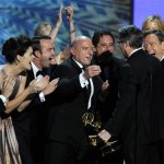The cast of "Breaking Bad," from left, Bob Odenkirk, Betsy Brandt, Aaron Paul, Dean Norris and Bryan Cranston, right, congratulate creator Vince Gilligan, second right, after he accepted the award for outstanding drama series at the 65th Primetime Emmy Awards at Nokia Theatre on Sunday Sept. 22, 2013, in Los Angeles. (Photo by Chris Pizzello/Invision/AP)