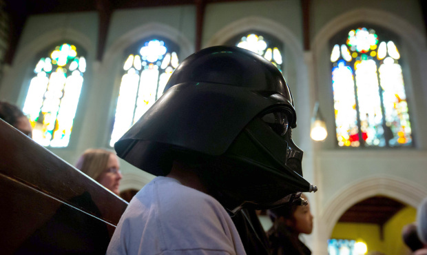 Brandon Young wears a Darth Vader helmet while attending a Star Wars-themed church service with his...