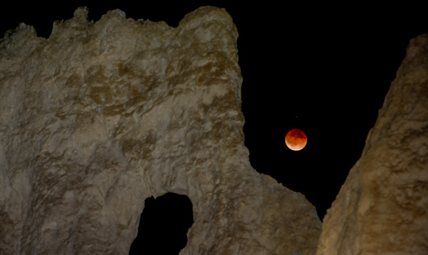 The moon is eclipsed by the Earth’s shadow early Tuesday as seen from Bryce Canyon, Utah. (AP...