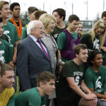 Michael Higgins, the president of Ireland, and his wife Sabina pose for a photo with students from Skyline High School Thursday, Oct. 22, 2015, in Sammamish, Wash. Higgins was at the school to speak to students and watch a game of Gaelic Football, which is taught in Skyline's physical education program. The visit was part of a four-day stop in the Seattle area. (AP Photo/Ted S. Warren)