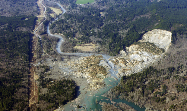 This aerial photo taken Monday shows the massive mudslide that has left dozens missing. (AP Photo/T...
