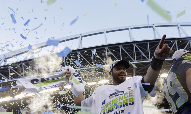 Seattle Seahawks’ Russell Wilson celebrates after overtime of the NFL football NFC Championsh...