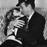 FILE - This 1944 file photo originally released by Warner Bros. shows actor Humphrey Bogart, right, holding actress Lauren Bacall in a scene from, "To Have and Have Not." Bacall, the sultry-voiced actress and Humphrey Bogart's partner off and on the screen, died Tuesday, Aug. 12, 2014 in New York. She was 89. (AP Photo, Warner Bros. Pictures, File)